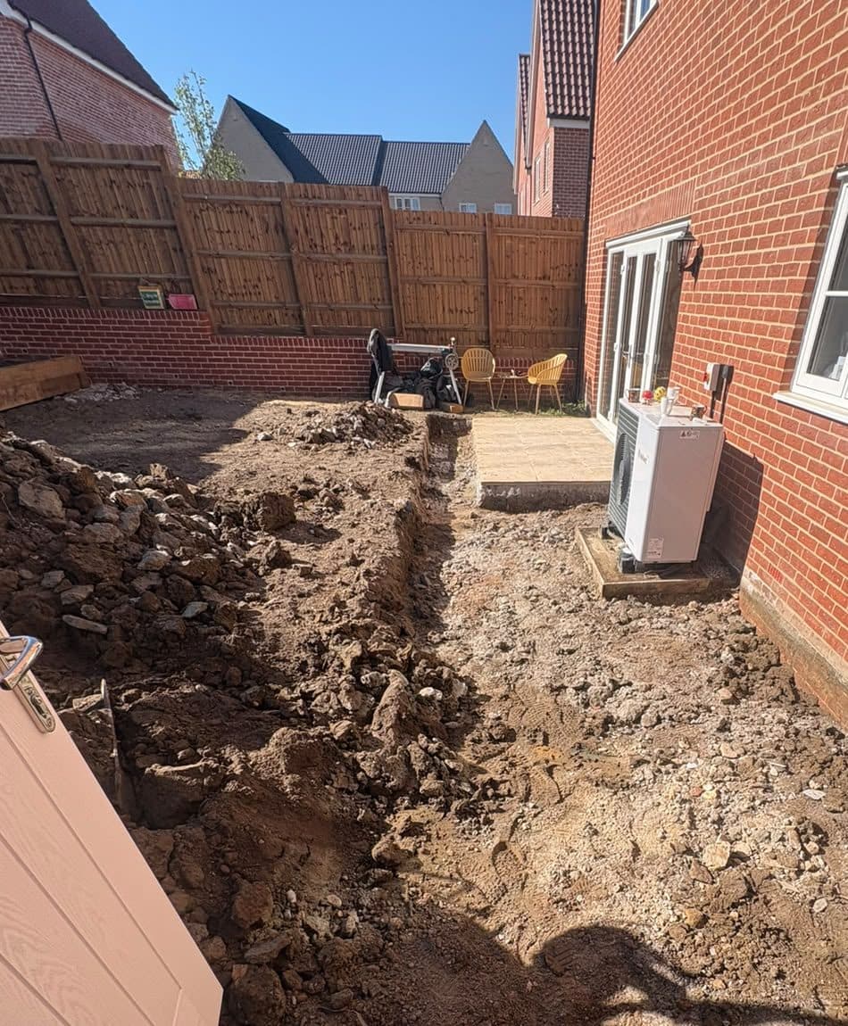 Ground dug out beside a new-build house, ready for a patio