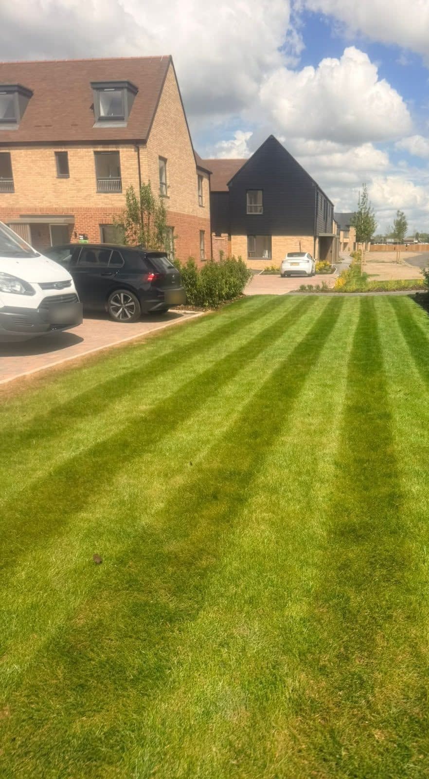 Freshly striped front lawn on a new-build development